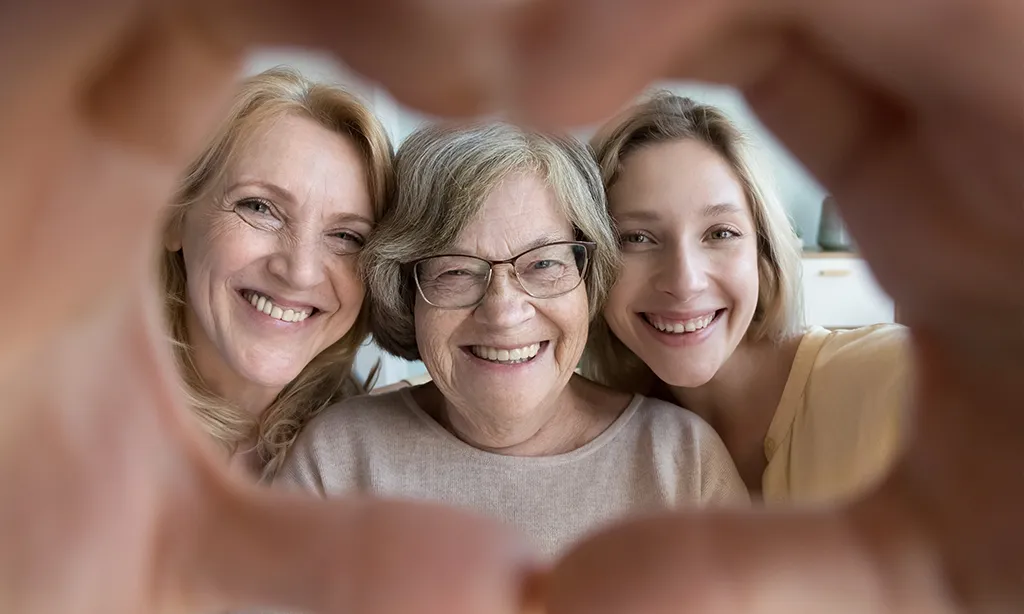 Joyful grandma, mature mother and adult granddaughter looking at camera