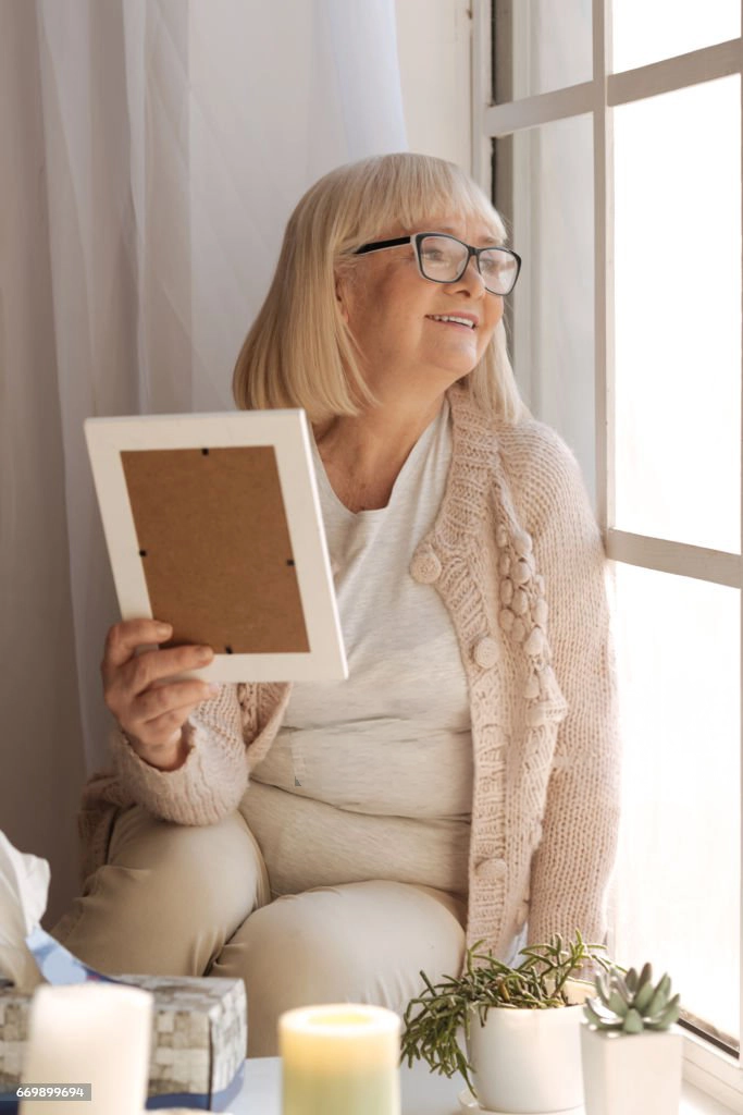 elderly woman looking out the window copy