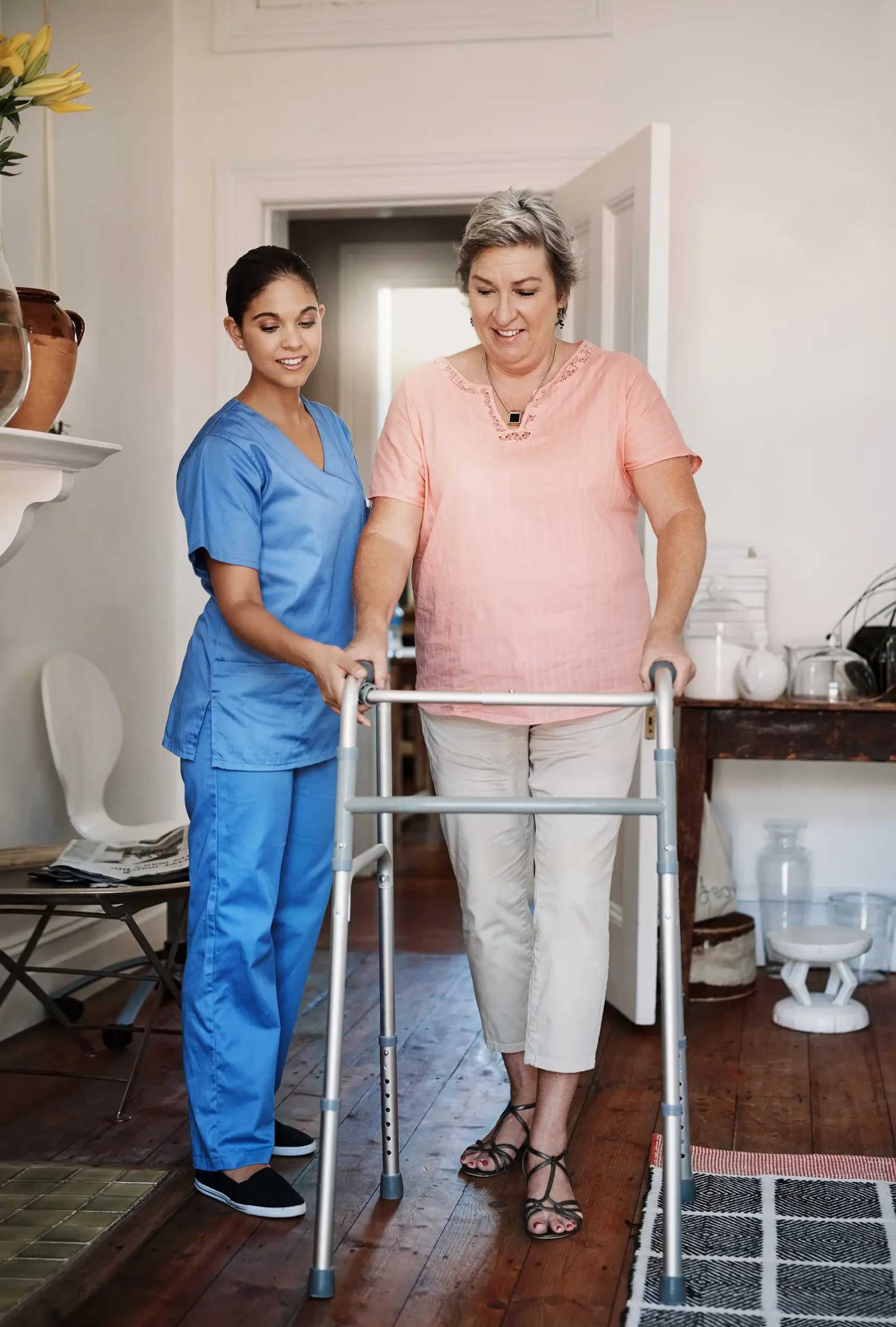 Nurse, woman with disability and walking frame for homecare support, healthcare helping or muscle rehabilitation. Caregiver, mature patient or people for Parkinson, arthritis or home nursing help